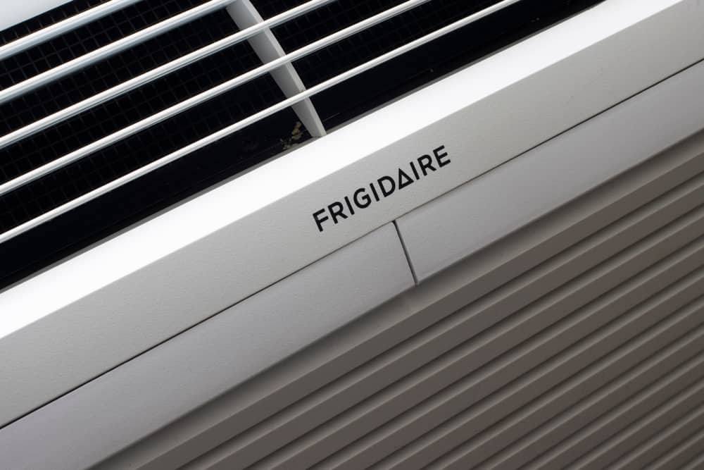A close-up shot of the "FRIGIDAIRE" logo printed on a white air conditioning or HVAC unit.